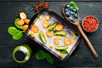 Yogurt with fruit, kumquat, kiwi fruit and apple. Healthy food, restaurant dish delivery. Top view. Free space for your text.