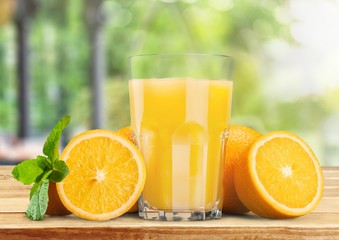 Orange juice and slices of orange on background