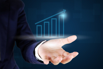 Businessman holding a growth graph.