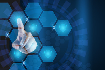 Businessman pointing shield icon in hexagonal virtual screen.Data protection and cyber security...