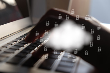 Cloud and lock icon on hand and keyboard background.Cloud computing and network security concept.