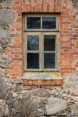 Exterior of an old stone and brick house with vintage window frame