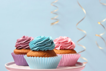 delicious cupcakes on a stand on a colored background with space to insert text. Festive background, birthday