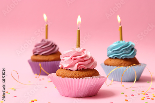 Delicious Cupcakes With Candles On A Colored Background Festive