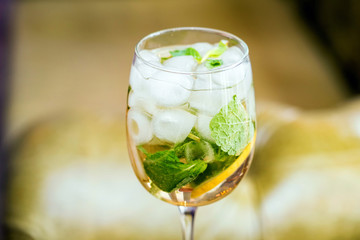 Glass with delicious fresh homemade mojito on blurred background