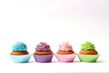  tasty cupcakes on a white background.
