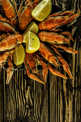 Boiled crayfish on a rough wooden background