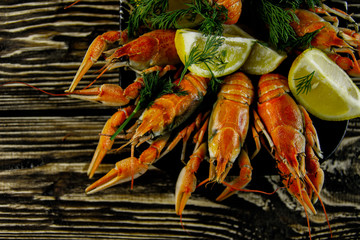 Boiled crayfish on a rough wooden background