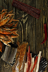 Dried fish, crab meat and crayfish on a wooden background