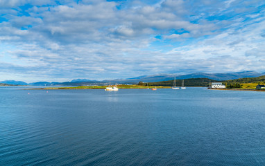 Obraz premium View of the Sandnessundet strait and Tromsoya island in the distance, Troms county, Norway.