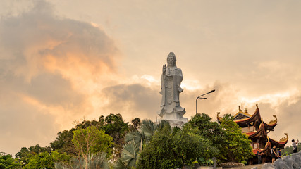 Fototapeta premium Ho quoc pagoda in phu Quoc island. Monument of Lady buddha in a beautiful sunset in Vietnam