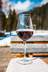 A glass of red Cabernet wine in a lodge in Cortina d'Ampezzo, Dolomites, Italy