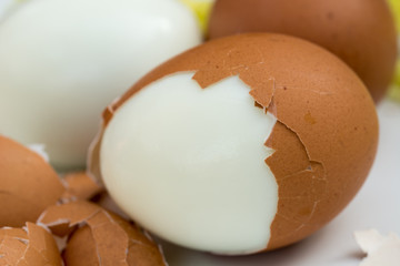 boiled eggs on plate with broken eggshell