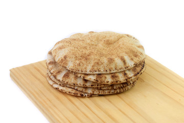 Pita bread isolated on white background in wooden spatula. Traditional food of Arabic cuisine