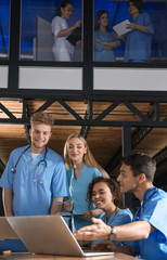 Group of smart medical students with gadgets in college