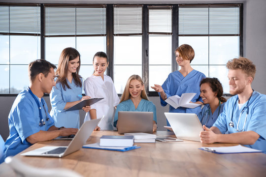 Group Of Smart Medical Students With Gadgets In College