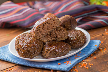 cutlet cut in half on the background whole on a plate