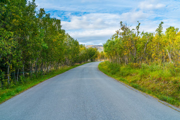 Naklejka premium Empty road on Hakoya - a 3.69-square-kilometre island located between the islands Kvaloya and Tromsoya in Troms county, Norway