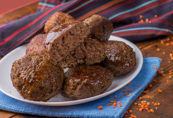 cutlet cut in half on the background whole on a plate