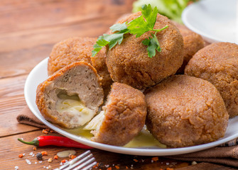 slice of cut cutlet stuffed with cheese. Hot melted cheese inside cutlet