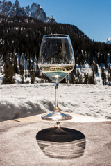 A glass of white sparkling Prosecco wine in a lodge in Cortina d'Ampezzo, Dolomites, Italy