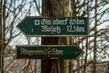 Alte verwitterte grüne Wegbeschilderung aus Holz  mit Handbeschriftung in der Uckermark