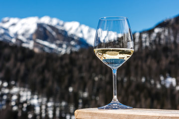 A glass of white sparkling Prosecco wine in a lodge in Cortina d'Ampezzo, Dolomites, Italy
