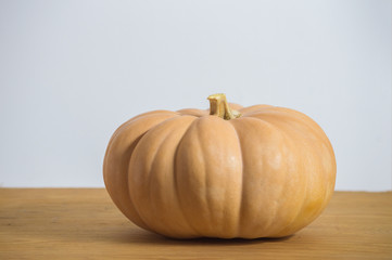 pumpkin isolated on wooden board and white background