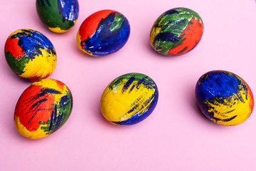 Easter multi-colored eggs, paints and brush on a table. Preparation for a holiday