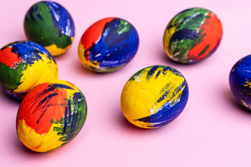 Easter multi-colored eggs, paints and brush on a table. Preparation for a holiday
