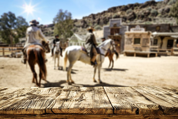 Naklejka premium Wooden table of free space for your decoration and wild west background 