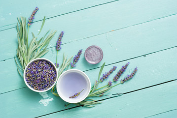 cup of lavender tea with a pile of fresh flowers, syrup, bunch, on blue wood table background