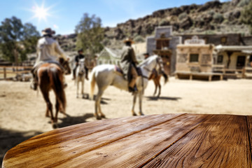 Wooden table of free space for your decoration and wild west background 