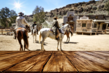 Wooden table of free space for your decoration and wild west background 