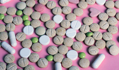 harmaceuticals antibiotics pills medicine /colorful antibacterials pills on pink background /capsule pill medicine. Creative idea. Drugs. Sad. Die. Illness