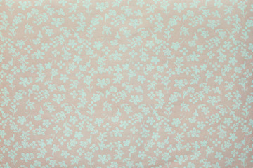 A piece of fabric with the image of small flowers in pastel colors