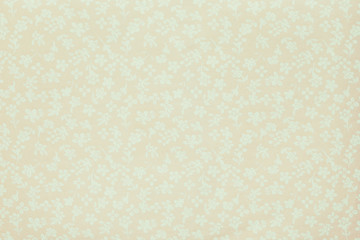 A piece of fabric with the image of small flowers in pastel colors