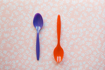 two plastic spoons for children on a fabric background