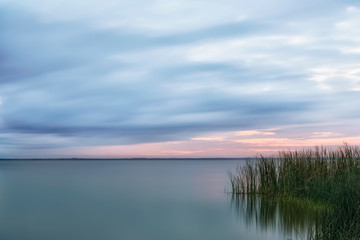 Fototapeta na wymiar Sunrise over the still waters