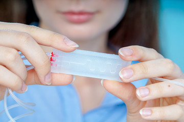 Girl holding polymers Bio-MEMS biomedical microelectromechanical systems / LOC lab-on-a-chip device (concept design)