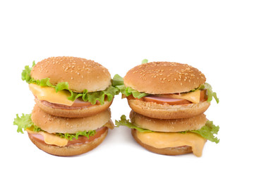 Hamburger with sausage and cheese with fresh lettuce. Four hamburgers isolated. Top view
