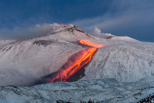 Etna volcano - lava flows and strombolian explosions from Southeast Crater - Snow landscape