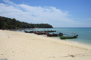 Fototapeta na wymiar February 16, 2019. Krabi, Phi Phi island, Thailand. Sea view, yellow sand beach, boats at the shore.