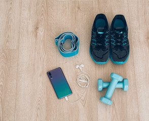 Cool runner sneakers with smartphone, earphones and dumbbells