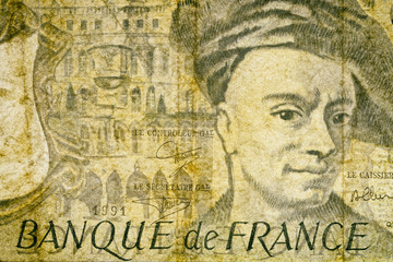 Close-up at an ancient, outdated fifty Francs French banknote. Details of fiber paper, with all flaws, watermarks and traces of usage.