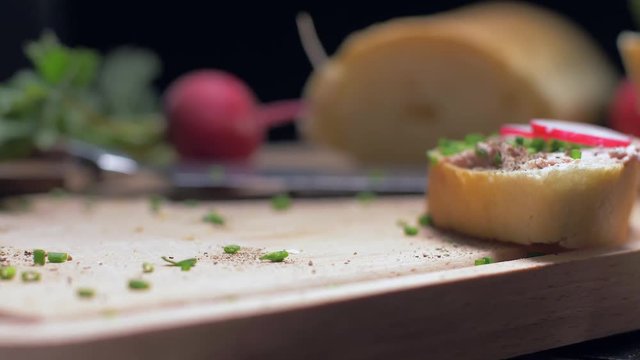 Taking a sandwich with a pate from the wooden board