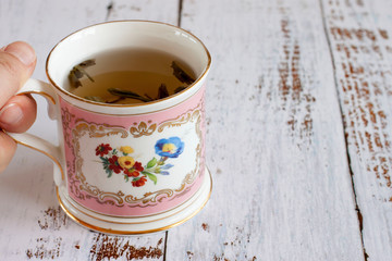 Female hand with a Cup of tea.