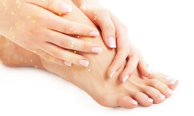 Perfect hands on female feet isolated on white background