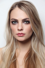 Fototapeta premium Young beautiful woman with smoky eye make-up