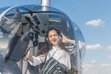 Young smiling woman helicopter pilot